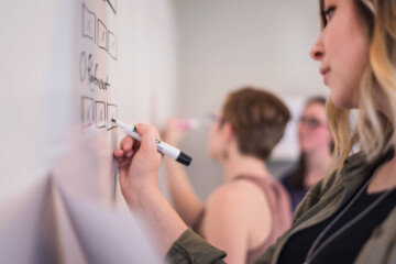 Women writing on a whiteboard