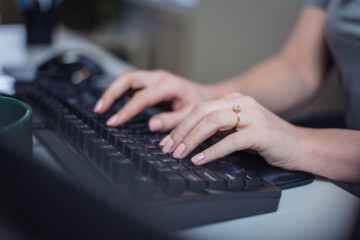 hands typing on keyboard