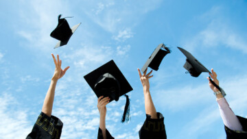 college students throwing caps