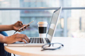 Black woman working at Macbook computer