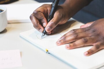 Person writing in notebook