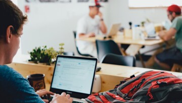 Man working on computer in coffeeshop