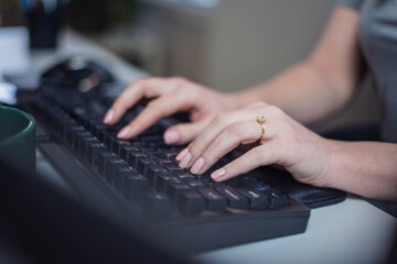 Woman typing on keyboard at Mad Fish Digital