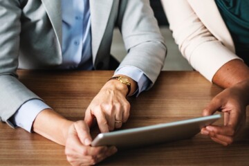 Two people working with iPad