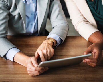 Two people working with iPad