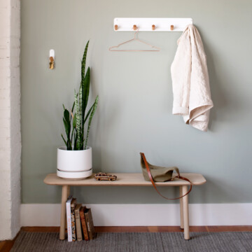 schoolhouse entryway with a bench and coat hooks