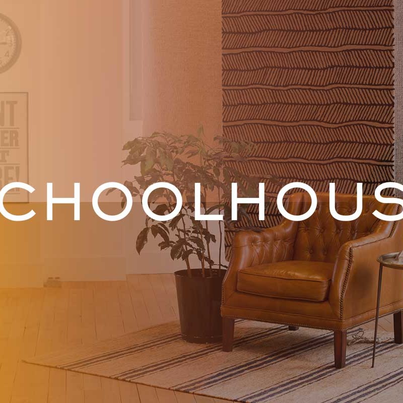 Schoolhouse logo on image of styled living room