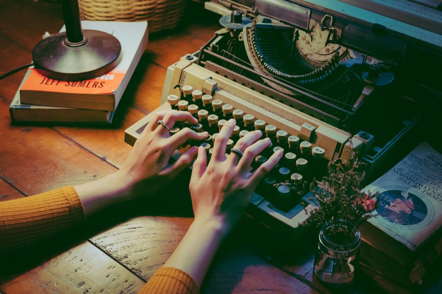 Woman typing on a vintage style typewriter