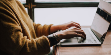 person typing on laptop