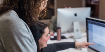 Two people looking at a computer