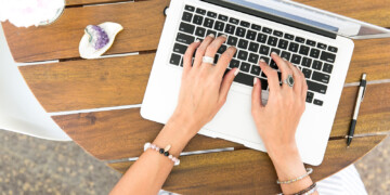 woman typing on a laptop