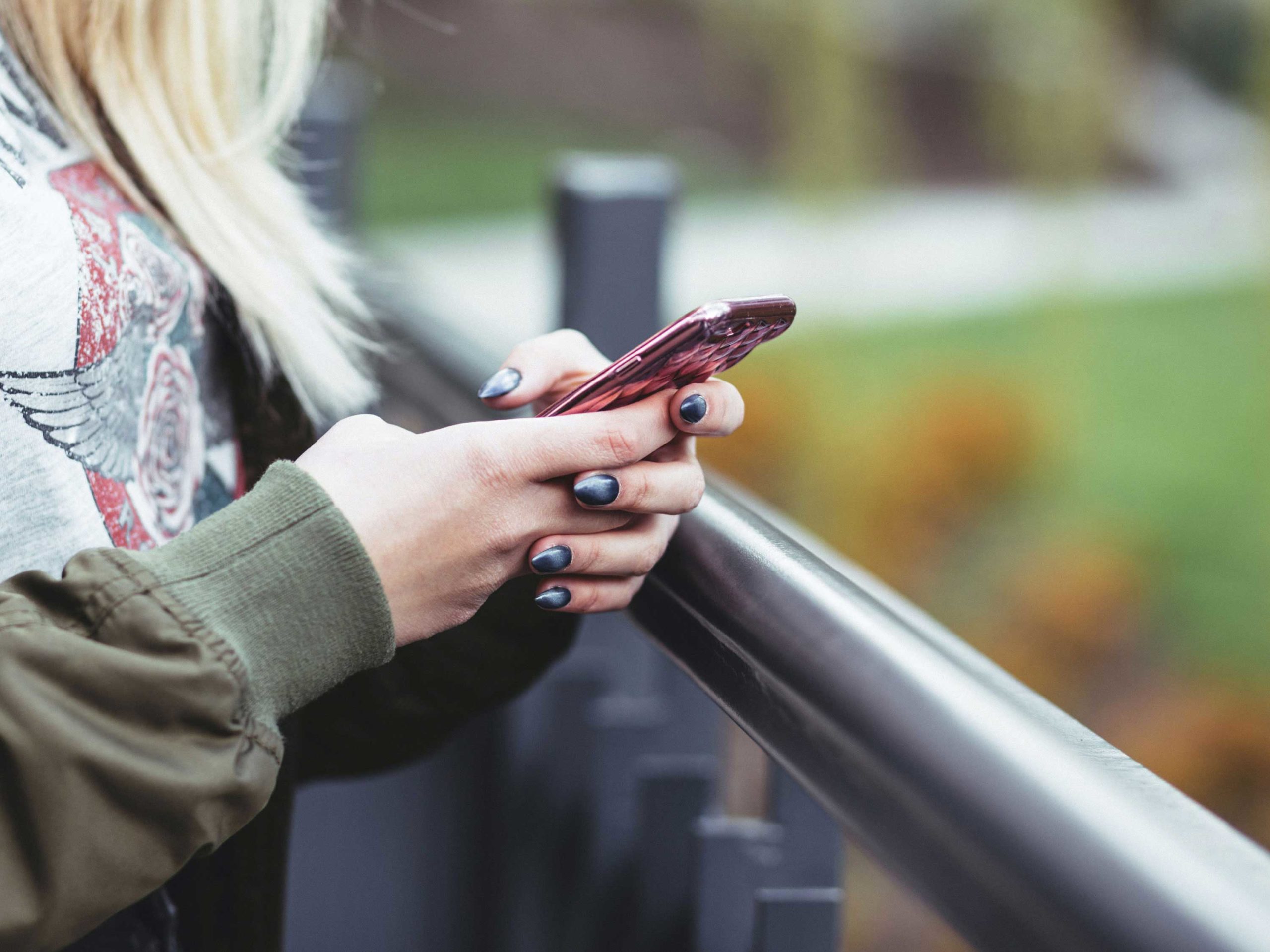Woman texting outside