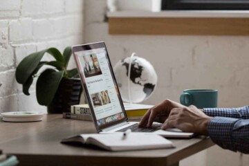 Person sitting at a desk searching on a laptop