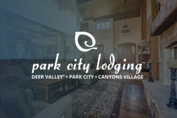 Park City Lodging logo on image of lodge living room