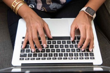Person typing on a laptop computer.