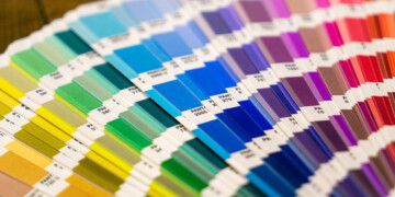 Close up of a rainbow array of Pantone color swatches.