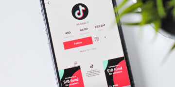 The TikTok app is shown on the screen of a phone in a close up.