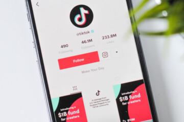 The TikTok app is shown on the screen of a phone in a close up.