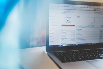 A laptop computer on a desk is open and showing the Google Analytics website.