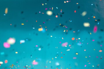 Multicolored confetti on blue background
