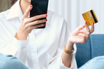 woman holding mobile phone and credit card