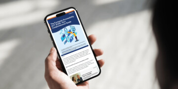 Person holding smart phone reading an article about the EAA.