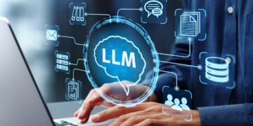 Person in blur shirt typing on laptop for LLM search.